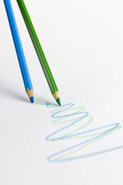 Multicolored art pencils on a white background. For professional artists, crafters, handmade. Production of paintings, drawings and children's creativity.