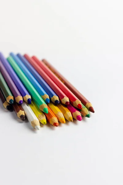 Multicolored art pencils on a white background. For professional artists, crafters, handmade. Production of paintings, drawings and children\'s creativity.