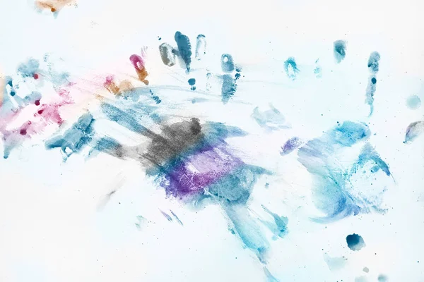 Color splash and multicolored handprints on white background, blue cold tone