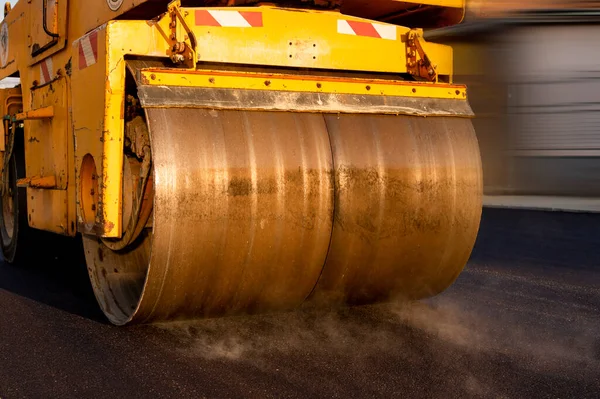 Industrial construction equipment, asphalt paving works. asphalt roller makes the smooth road surface