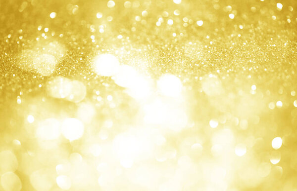Gold glittering Christmas lights. Festive abstract glitter bokeh background	