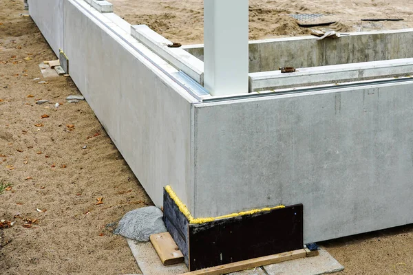 The beginning of building construction with the assembly of prefabricated foundation concrete blocks and steel columns, prefabricated constructions
