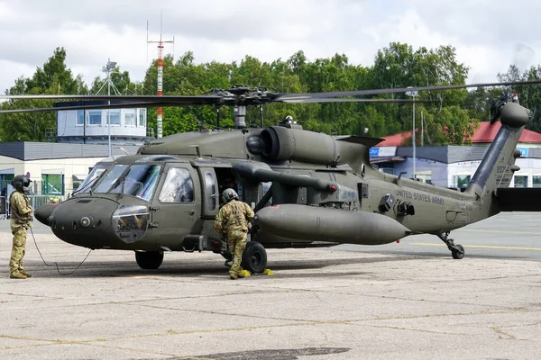 stock image Liepaja, Latvia - August 7, 2022: US Army Sikorsky UH-60 Black Hawk military helicopter with crew after landing at the airport during the Baltic International Air Show