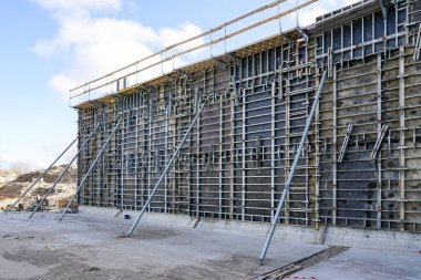 Construction site of a huge reservoir for the drinking water export terminal using concrete formwork with a folding mechanism