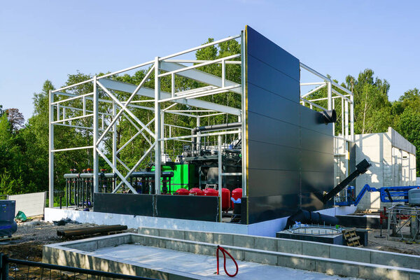 Steel framework of new modern unfinished wood chip biofuel heat power station before installing wall sandwich panels