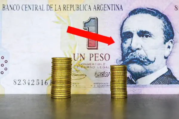 Concept of falling value of Argentine currency, symbol of rising inflation, falling purchasing power, fluctuations in the value of the peso