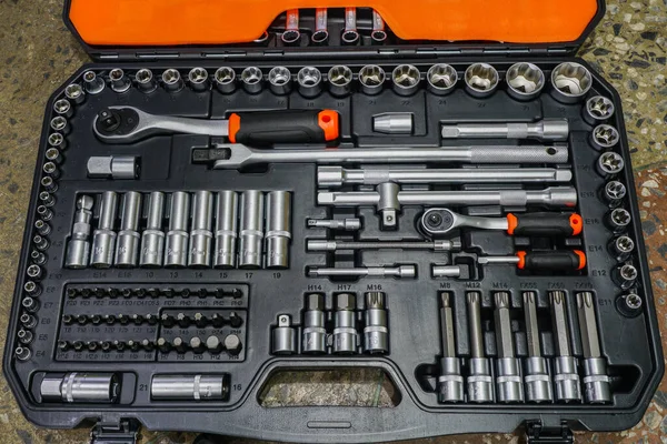 Universal tool box, tool kit closeup with set of hex, torx and screwdriver bits, and various sizes of ratchet wrench sockets
