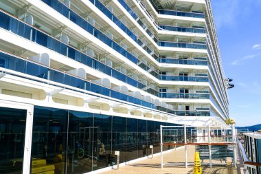 La Spezia, Italy- May 28, 2024: A view of the glass-railed balconies on the deck of the cruise ship MSC Seaview clipart