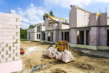 Construction site of a new residential terraced house from expanded clay blocks with concrete covers and thermally insulated foundations clipart