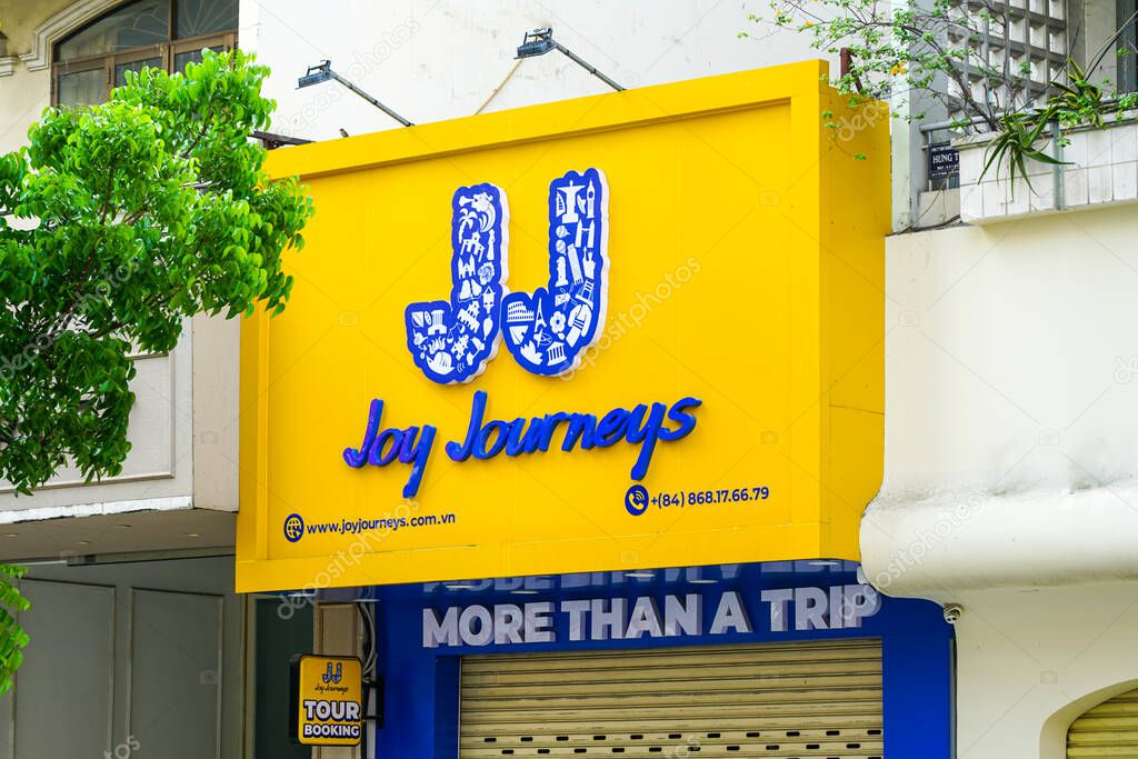 Ho Chi Minh City, Vietnam - March 16, 2025: Joy Journeys tour booking advertisement outside its office on Ly Tu Trong Street, Saigon