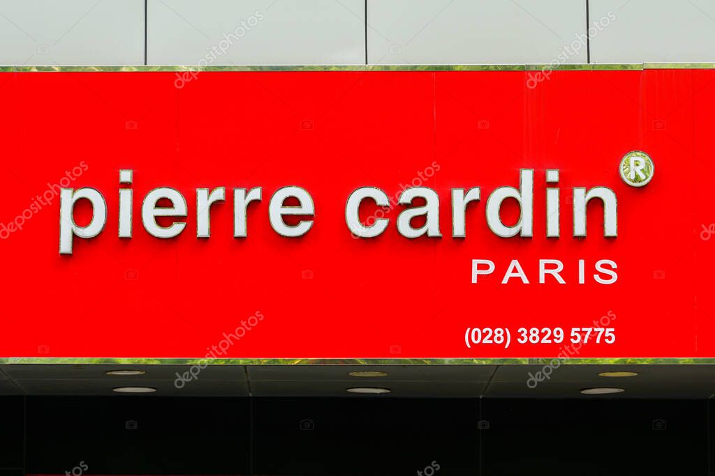 Ho Chi Minh City, Vietnam- March 16, 2025: Storefront sign of Pierre Cardin Paris fashion brand on vibrant red panel featuring contact number and logo