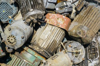 Geri dönüşüm için yıpranmış ve aşınmış elektrikli motorların yakın çekimi, pas, boya aşınması ve endüstriyel metal dokuları gösteriyor
