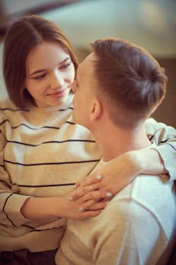 Yakışıklı bir genç adam ve güzel bir kız şefkatle sarılıp birbirlerinin gözlerinin içine bakarlar. Aşk konsepti. Mutlu çift.