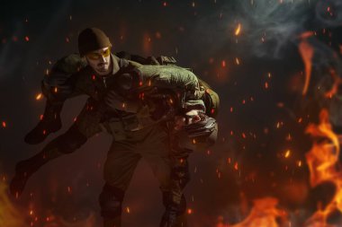 Cesur bir asker yaralı yoldaşını savaş alanından alevler içinde omuzlarında taşır. Savaş konsepti. 