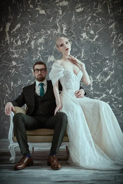 stock image Portrait of a gorgeous bride in luxury wedding dress and handsome, elegant groom in vintage interior. Wedding fashion.