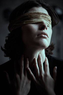 İnsanların acı çekmesi, körlük. Koyu renk saçlı, sargılı gözlü bir kız sakince karanlık bir yerde duruyor acı çekiyor ve kendi içine çekiliyor.. 