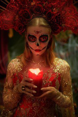 Dia de los Muertos. Santa Muerte 'de. Muhteşem Calavera Catrina şenlikli zengin elbisesi ve başlığıyla elinde mumla şatoda duruyor. Kafatası şekeri kız. Ölüler Günü. Cadılar Bayramı.