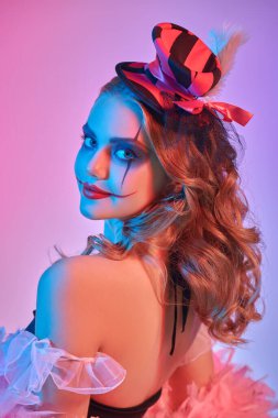 Portrait of a beautiful and scary young clowness against a colorful background. Makeup and hairstyle. Character for Halloween. Beauty and Horror. clipart