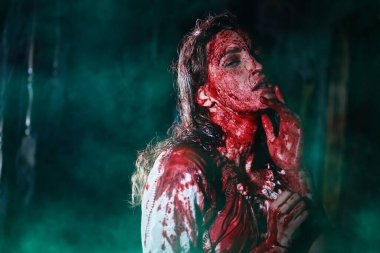 Vampirler. Kana bulanmış zavallı masum bir kızın portresi. Karanlık bir odada zayıf duruyor. Korku, gerilim. Cadılar Bayramı. Boşluğu kopyala.