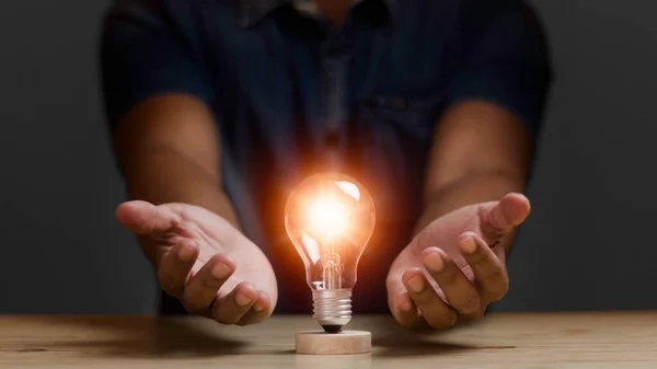 Man Protecting Light Bulb Shining Orange Illuminate Creative New Idea — Stock Photo, Image