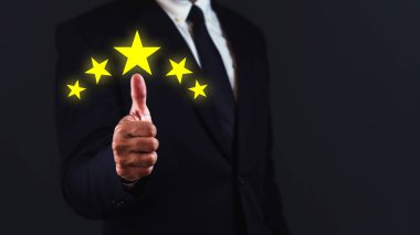 Müşteri memnuniyeti kavramı. İşadamı, koyu mavi arka planda beş yıldızla boy gösteriyor..