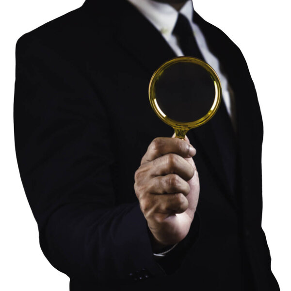 Businessman using magnifying glass isolated on white background.