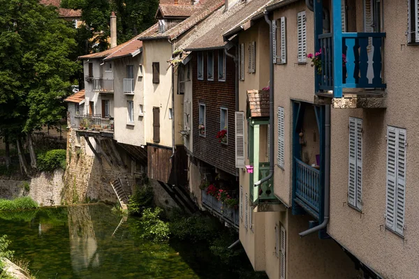 Old houses near the river in Arbois on a summers day in the Jura, France.