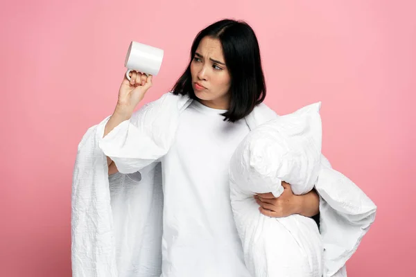 stock image Dissatisfied asian woman having no coffee and feeling sad at the morning isolated on pink coloured background. Bedtime concept