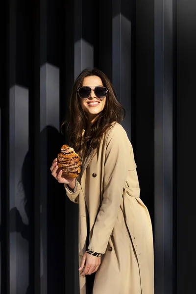 Krásná Dívka Slunečních Brýlích Stojí Drží Čerstvý Croissant Ruce Venku — Stock fotografie