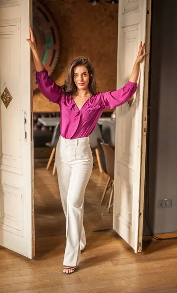 Beautiful Young Brunette Woman Purple Blouse White Pants Posing Indoor Stock Photo