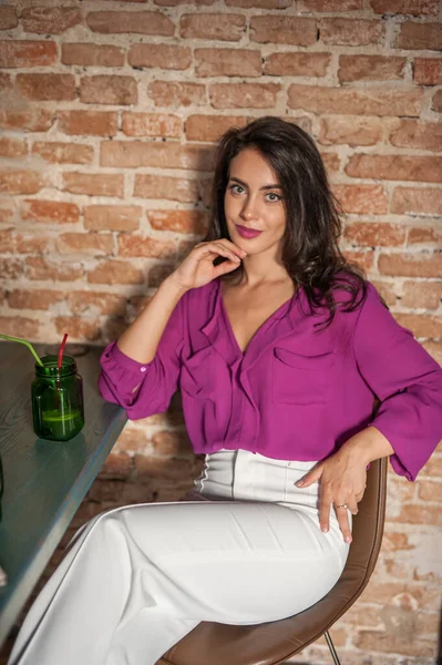 Beautiful Young Brunette Woman Purple Blouse White Pants Posing Indoor Stock Image