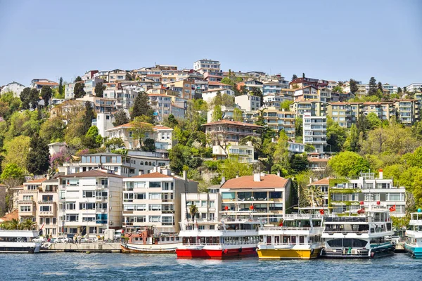 Small port on Bosphorus strait in Turkey and sea front houses above on the hill