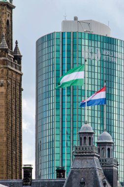 Rotterdam, The Netherlands, March 19, 2024: the flags of the city of Rotterdam and of the Netherlands on the towers of the city hall  clipart