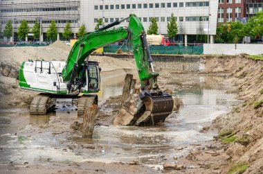 Rotterdam, The Netherlands, June 11, 2024: work in progress on the removal of old quay structures as part of the Rijnhaven reclamation project clipart