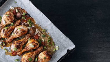 baked chicken drumsticks with sesame, honey and soy sauce, onion and spices