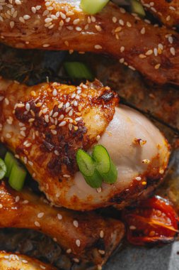 Baked chicken legs. Baked chicken drumstick on paper