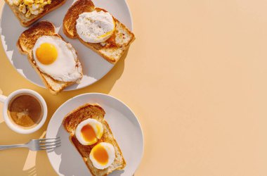 fried Toast bread with four different types of cooked chicken eggs, scrambled eggs, fried eggs, poached egg and creamed egg. Breakfast of chicken eggs. clipart