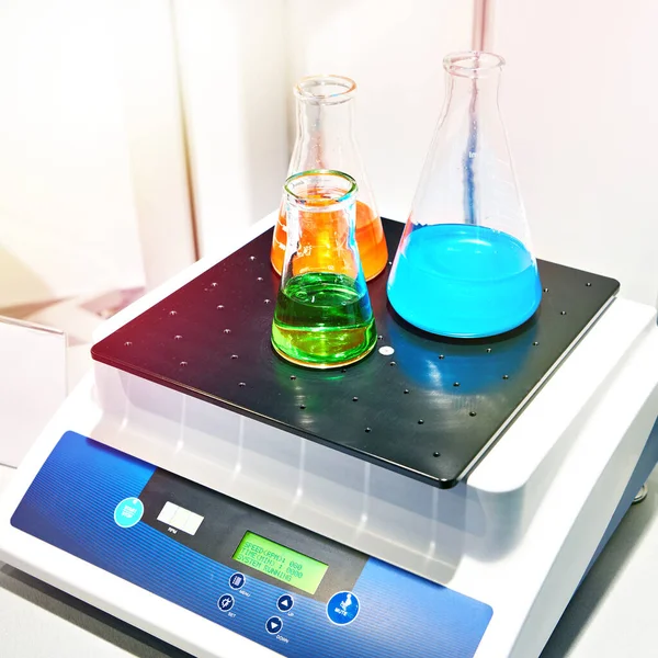 Laboratory shaker and flasks with solution