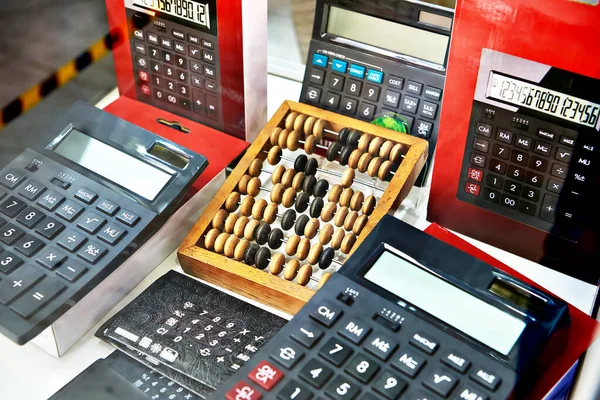 Wooden abacus and modern electronic calculators