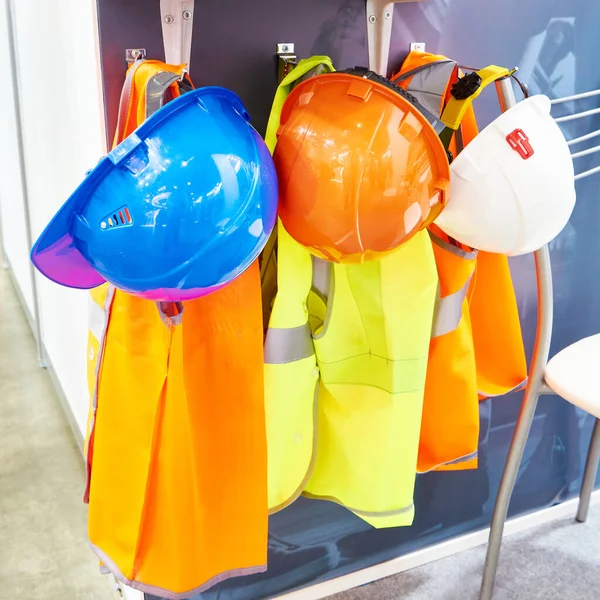 Protective construction helmets and reflective vests for workers