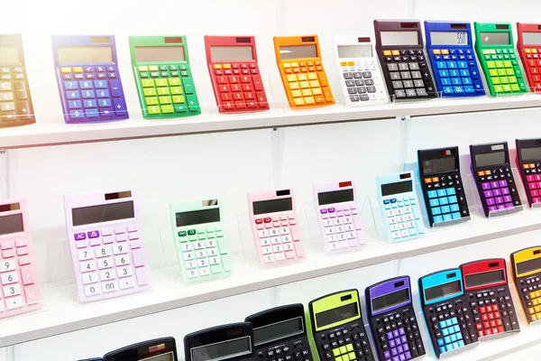 Colorful calculators on showcase in stationery store