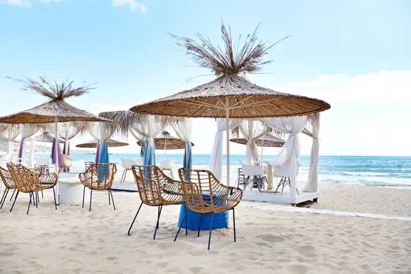 Umbrellas, chairs and tables of the beach cafe