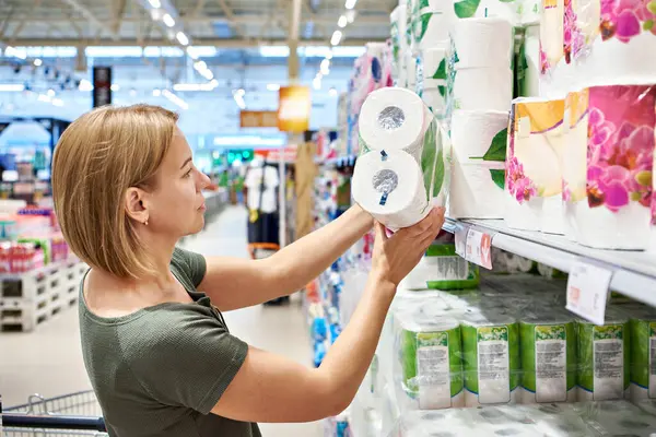 Woman buying toilet paper in a store