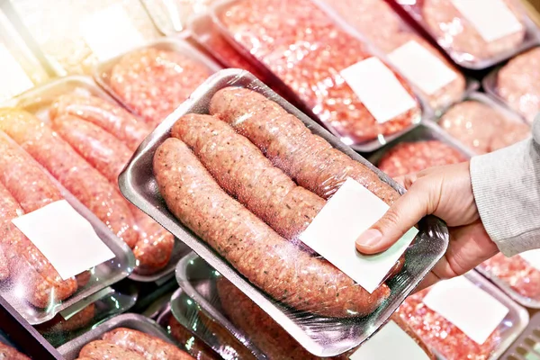Meat sausages for grilling in package in store