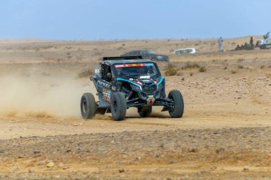 Al-Kharj, Saudi Arabia - January 10, 2023: The Can-Am Maverick XRS of South Racing Can-Am running Stage 9 of the Dakar Rally 2023 Edition. clipart