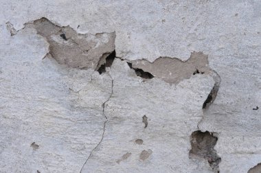 Çatlak beyaz beton duvar dokusu arka planı. Resmi kapat..