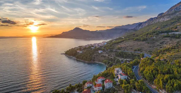 stock image Stanici village with main beach against sunset over the sea near the Omis in Croatia