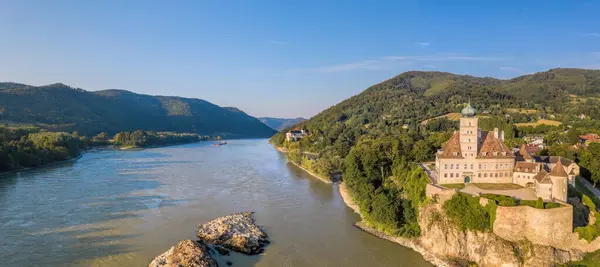 stock image Panorama of Wachau Valley with castle Schonbuhel above the Danube River against tourist boat in Lower Austria, Austria.