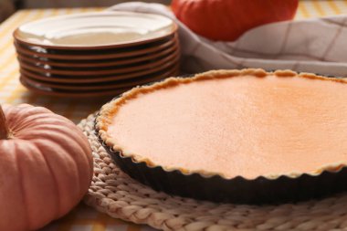 Delicious homemade pumpkin pie in baking dish on table