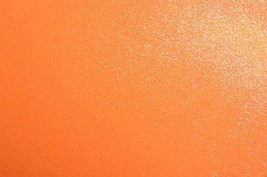 Turuncu arka planda parlak parlak parıltı, düz yatış. Metin için boşluk